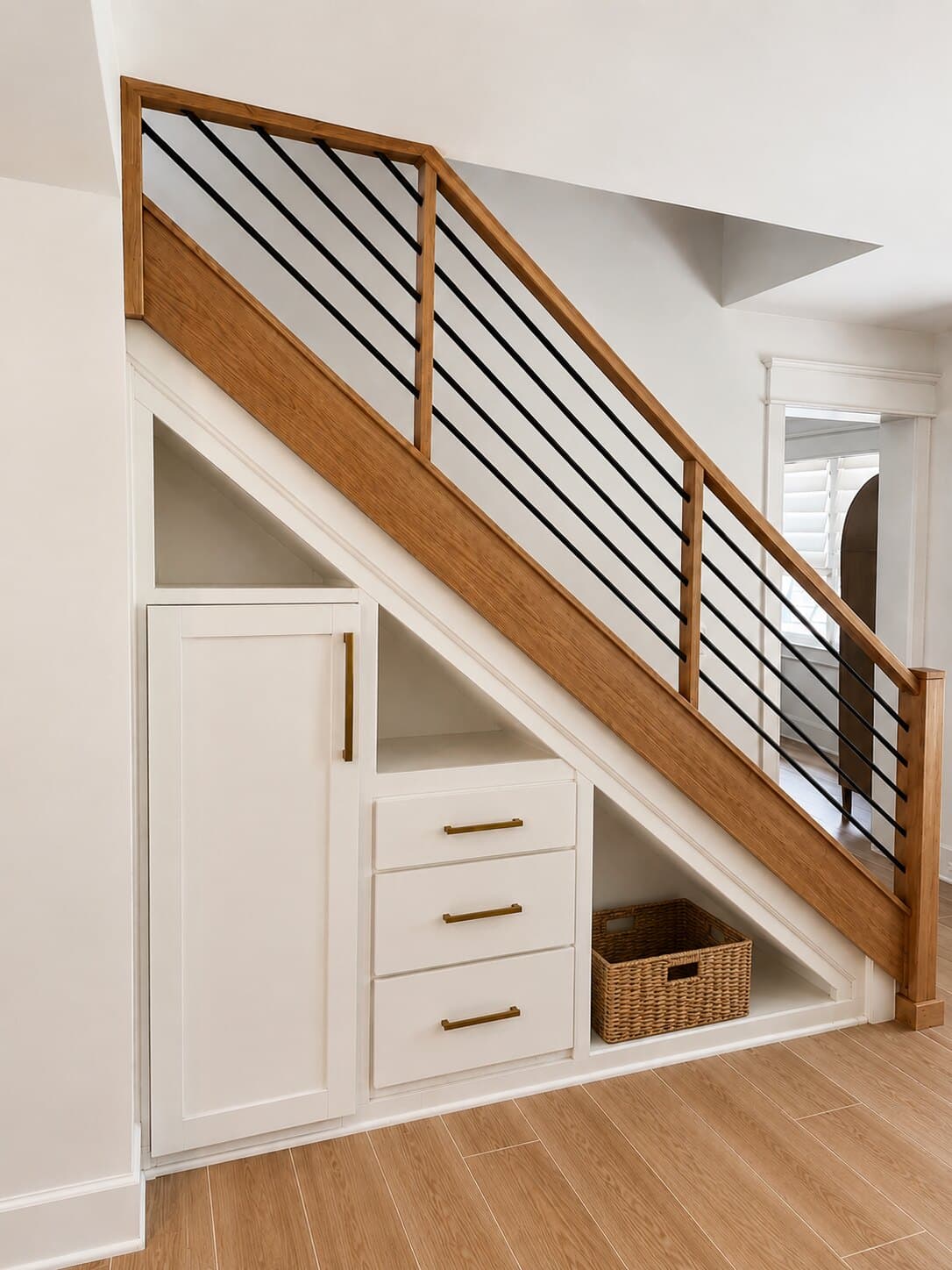 Storage tucked under the stairs.